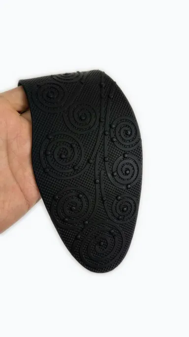 Real product photo: the insole flexes easily — matte black finish, soft and pliable
